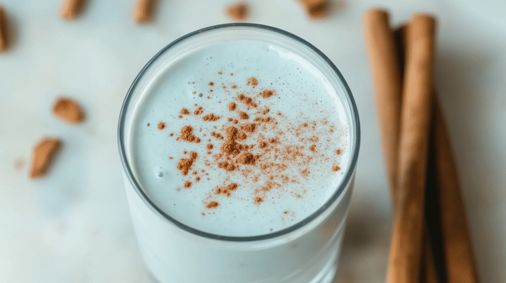 Does the Blue Salt Trick Really Work? The Truth About This Viral Stamina Boost 4 Glass of Blue Salt Trick drink topped with cinnamon powder, styled with cinnamon sticks on a marble background.