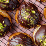 Dubai Chocolate Donut: The Ultimate Decadent Treat You Must Try 10 Top view of chocolate-glazed Dubai donuts filled with pistachio cream and sprinkled with crushed pistachios.