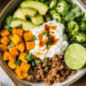 Sweet potato cottage cheese bowl with ground beef, cucumbers, jalapeños, and lime.