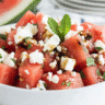 Fresh watermelon feta balsamic vinegar salad with mint in a white bowl.