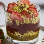 Dubai Chocolate Strawberry: The Viral Luxury Dessert That’s Taking Over Social Media 7 Layered Dubai chocolate strawberry dessert in a glass with pistachio, chocolate, and fresh strawberries.
