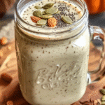 Creamy Bariatric Pumpkin Seed Recipe in a mason jar topped with pumpkin seeds, almonds, and spices, set on a rustic board with autumn ingredients.