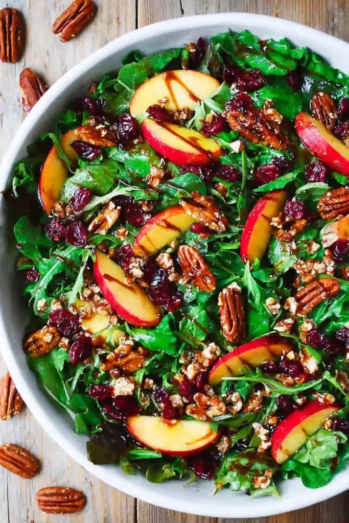 Apple Cranberry Pecan Salad with Honey-Orange Dressing: A Crisp and Colorful Holiday Side 6 This Apple Cranberry Pecan Salad brings together crisp apples, sweet cranberries, and crunchy pecans tossed with fresh greens and a light balsamic dressing โ a perfect balance of sweet and tangy flavors.