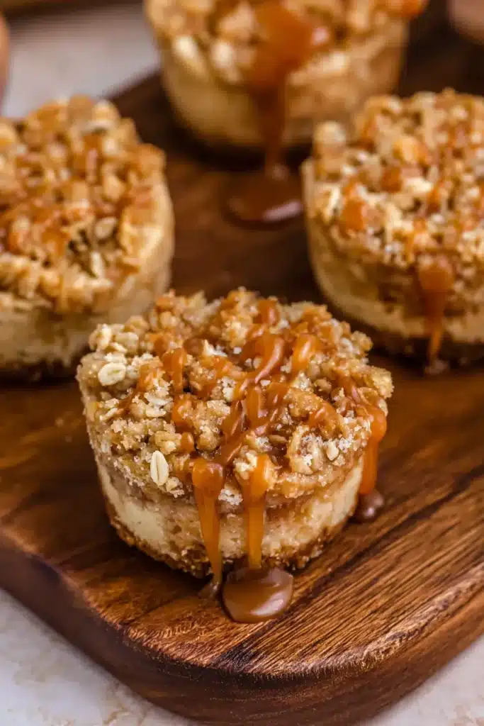 These Mini Apple Crisp Cheesecakes feature a creamy cheesecake base, cinnamon apple filling, and a buttery oat crumble topping — a cozy dessert perfect for fall gatherings.