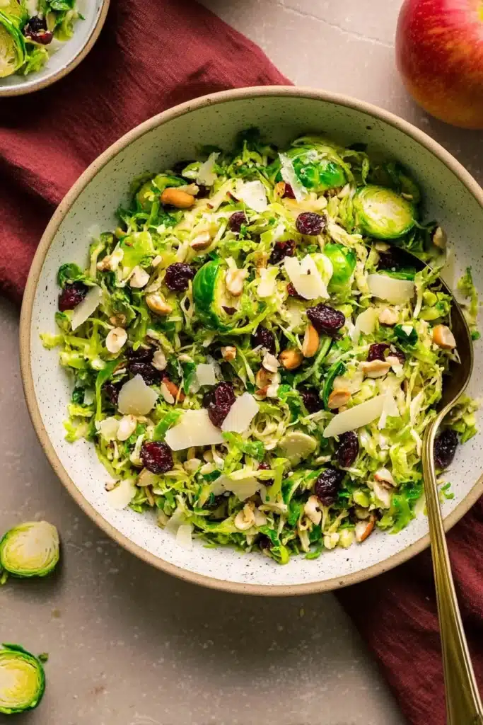 Shaved Brussels Sprouts Salad with Apples and Hazelnuts: A Fresh, Festive Holiday Side 8 This Shaved Brussels Sprouts Salad combines crisp sprouts, sweet cranberries, roasted hazelnuts, and Parmesan for a vibrant, healthy dish perfect for fall and winter gatherings.