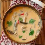 A comforting bowl of slow-cooked Tom Kha Soup — rich coconut milk broth infused with lemongrass, galangal, and lime leaves for the perfect Thai-inspired comfort meal.