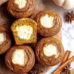 Soft, spiced pumpkin muffins filled with creamy cheesecake centers — these Pumpkin Cream Cheese Muffins are the ultimate cozy fall bake for breakfast or dessert.
