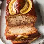 This Eggless Banana Bread is moist, rich, and full of banana flavor — beautifully baked with golden caramelized banana slices on top for a bakery-style finish.