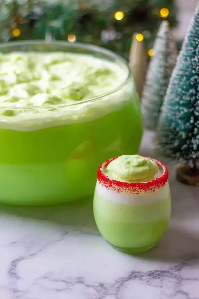 A fun and festive Grinch Punch made with lime sherbet and lemon–lime soda, perfect for Christmas parties.