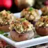 Christmas Stuffed mushrooms filled with golden toasted breadcrumb and herb stuffing arranged on a white serving platter.