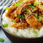 Simple dump-and-go crockpot teriyaki chicken, slow-cooked until tender and topped with sesame seeds and green onions.