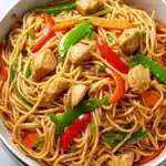 Chicken lo mein with stir-fried noodles, vegetables, and tender chicken in a savory sauce.