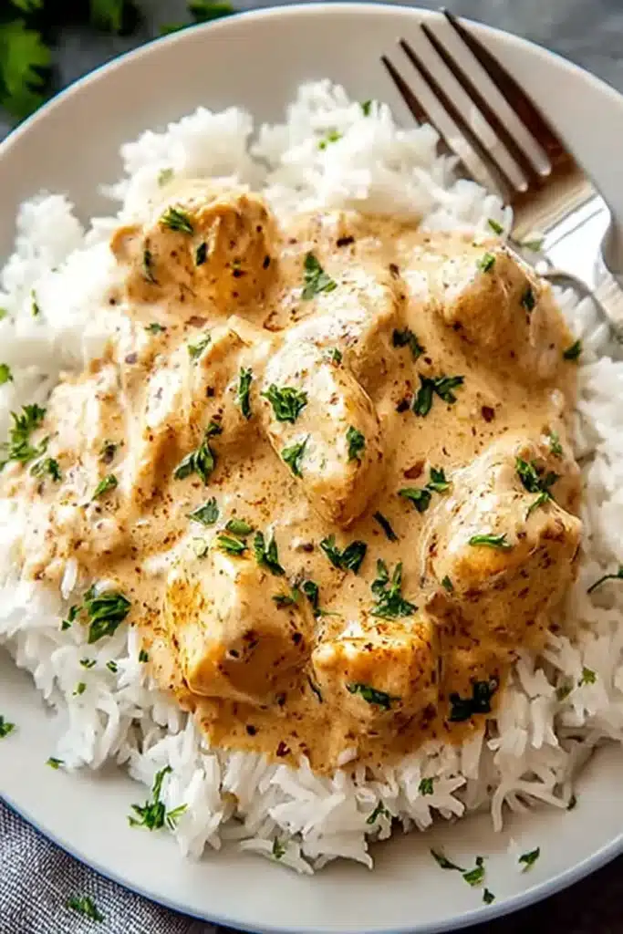 Creamy Smothered Chicken and Rice That Melts Into Every Bite 7 Tender chicken smothered in a rich, creamy seasoned sauce, served over fluffy rice for the ultimate comfort meal.
