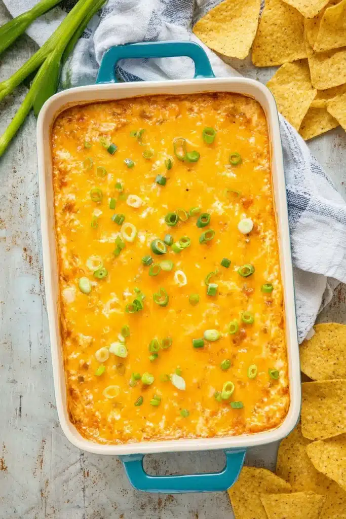 A warm and ultra-cheesy Texas Trash Dip loaded with beans, spices, and melty cheese — perfect for dipping with tortilla chips.